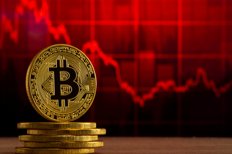 physical bitcoin standing at a wood table in front of a red grap_Adove_20231221